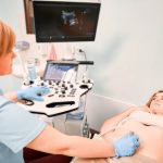 Female patient undergoing ultrasound procedure in medical center.