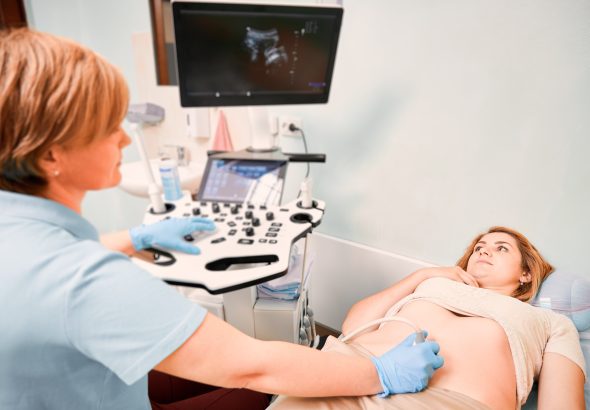 Female patient undergoing ultrasound procedure in medical center.