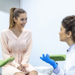 Gynecologist talking with young female patient during medical consultation in modern clinic. Patient with a gynecologist during the consultation in the gynecological office